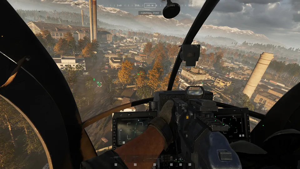 View from a helicopter's front seat over an industrial town with tall chimneys. The label under the compass reads CONTROL ZONE.